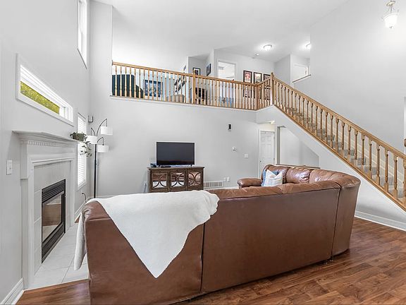 Living room with a view of upstairs loft