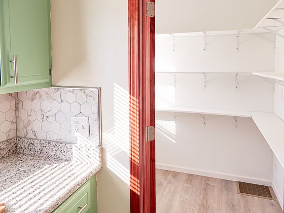 Oversized walk-in pantry with floor-to ceiling shelving