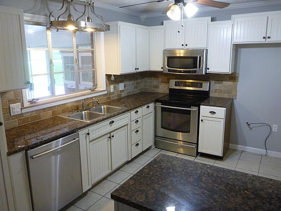 Stainless steel appliances , tile floor and granite countert