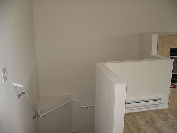 Stairs up to living room/dining room. Electrice Fireplace on Right.