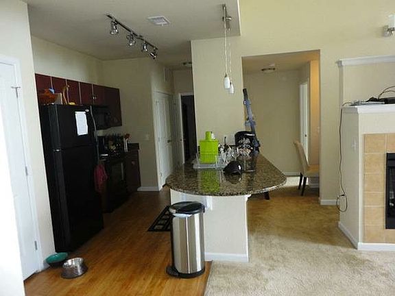 Kitchen with wood floors, granite counter tops and cherry ca