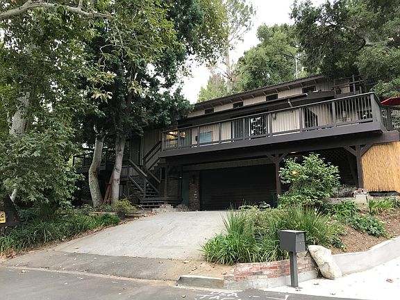 Front elevation (deck off dining room and kitchen), above garage. Front stairs to left.