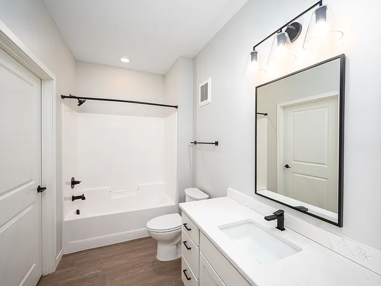 Elegant bathroom featuring sleek white cabinetry, modern fixtures, and a spacious bathtub with a bright, minimalist design. Elegant bathroom featuring sleek white cabinetry, modern fixtures, and a spacious bathtub with a bright, minimalist design.