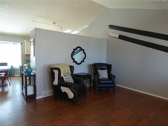 Front living room with vaulted ceilings, updated lighting.