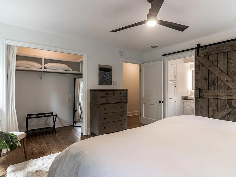 Bedroom #3 Master bedroom with plenty of storage in dressers, under king bed, and in closet. View of sliding barn door to Master Bathroom.