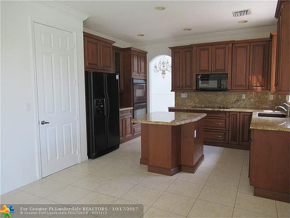 UPGRADED KITCHEN WITH WOOD CABINETS, GRANITE COUNTERTOPS, ISLAND, PANTRY, 2 OVENS, LOTS OF STORAGE.