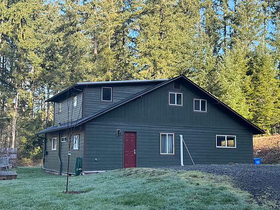 Rear of the house, with deck and side deck. Car, RV, and boat, parking.