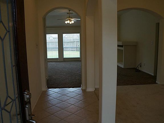 A view of the entry.  Tiled entry with arches & rounded corners through-out.
