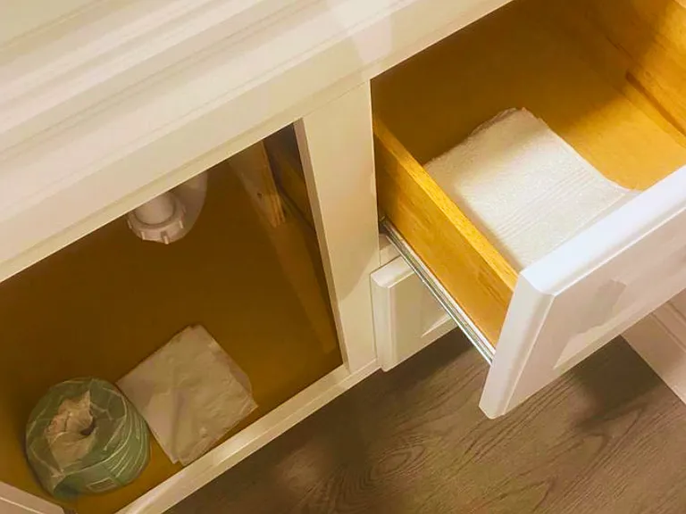 Bathroom includes essential amenities such as toilet paper and towels.