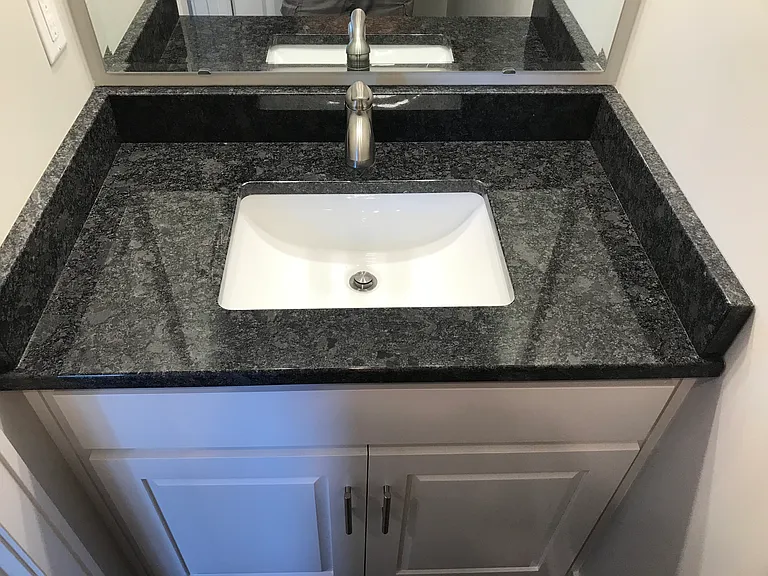 Powder Bath sink with granite top. All bathes and kitchen are granite tops