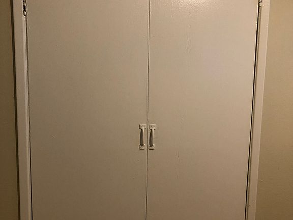 Separate stackable washer and dryer room.