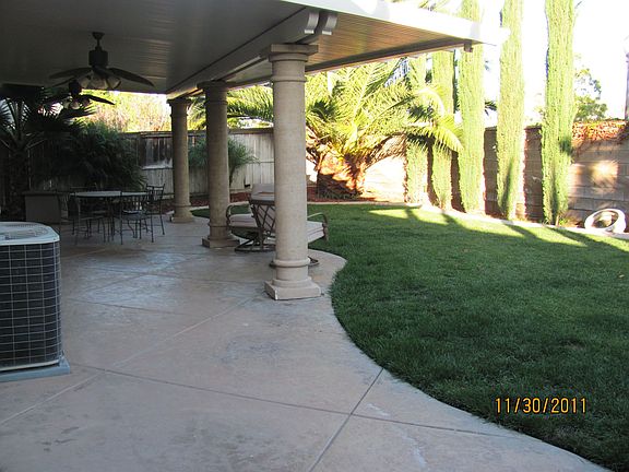 Covered patio with columnts, lights and two fans