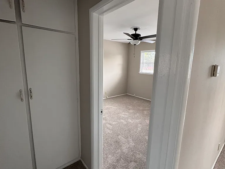 Split view of the hallway entrance from the living room and the first bedroom
