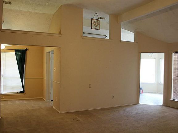 View from Den to formal dining on left and kitchen on the right.