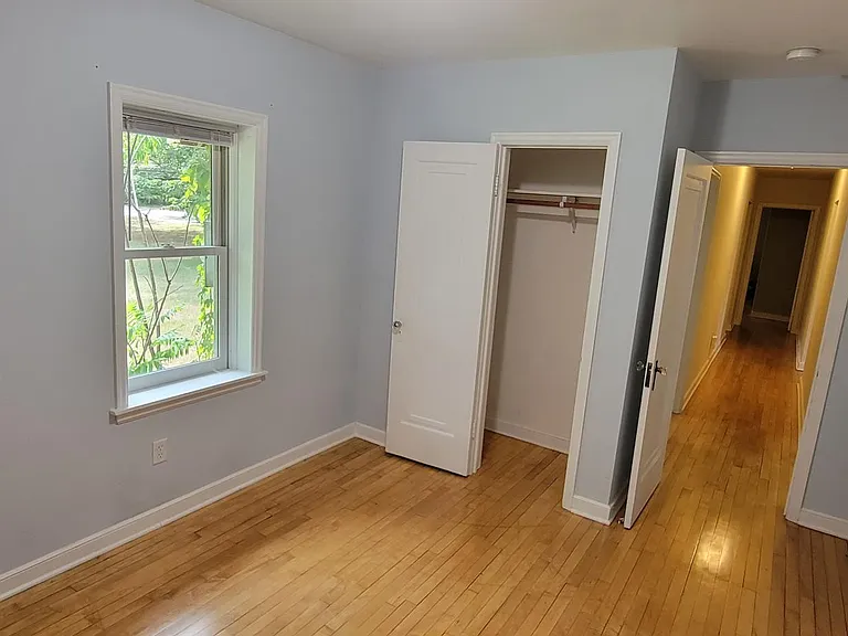 Bedroom 1. Closet goes all the way to the wall on the left.