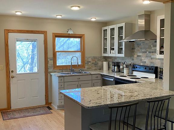 Kitchen with new refrigerator and dishwasher. Reverse Osmosis filtered drinking water system.