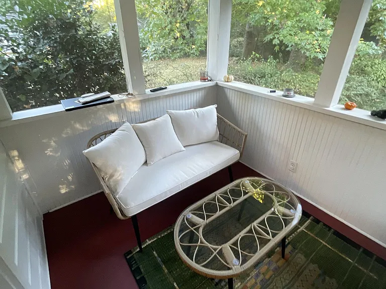 Screened in porch photo including example furniture