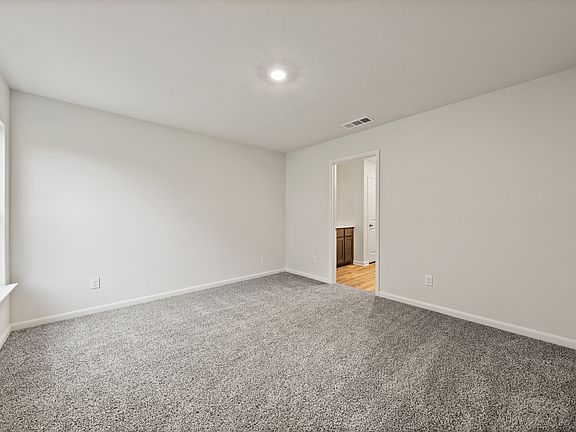 The master suite has a large bedroom, private bathroom and walk-in closet.