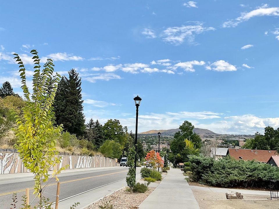 Enjoy a peaceful stroll along this picturesque suburban walkway, surrounded by natural beauty.