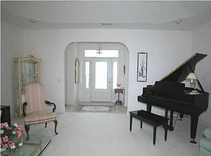 Tiled foyer opens to the formal living room...