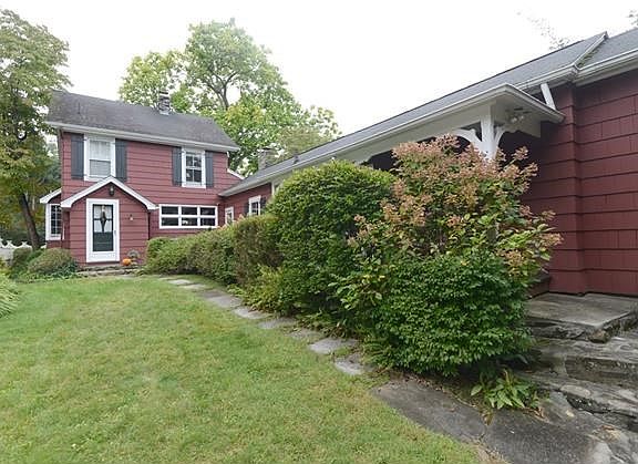 Pathway to the front door with beautiful flowering shrubs