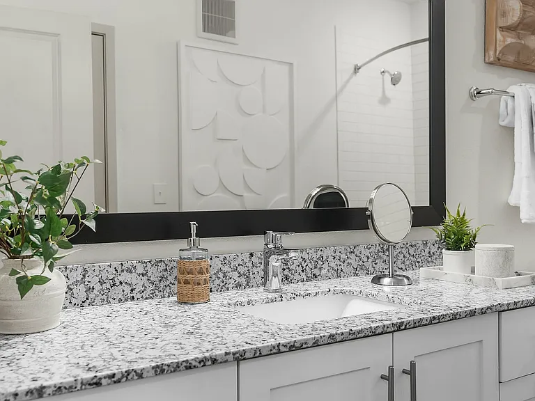 Experience elegance with this beautifully designed bathroom vanity, adorned with a granite countertop and tasteful accents.