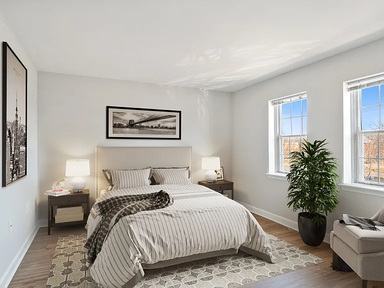 Your bedroom is spacious with natural lighting and wood floors