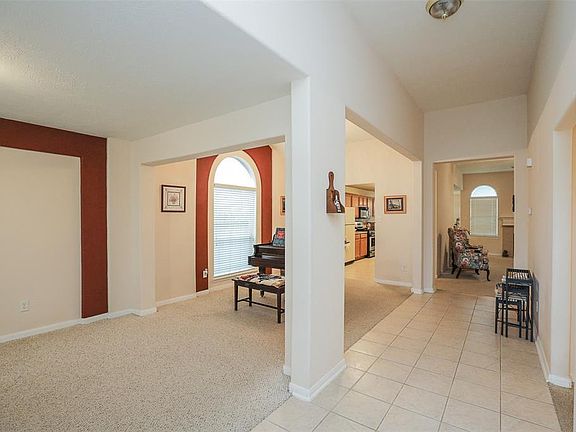 The formal living/sitting area and the formal dining area are on your left as you enter. Right now the baby grand piano has the dining area all to itself. Second and third bedrooms a jack and jill bath are on your right. Walk straight ahead into the 