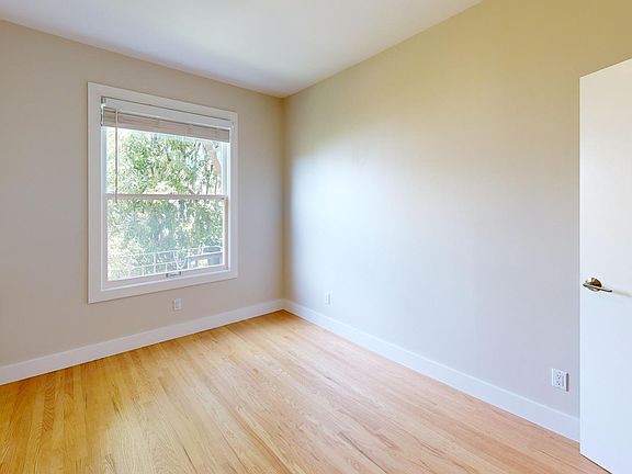 Bright bedroom with wood-like floor