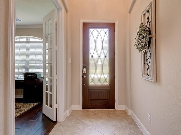 The entryway opens up to the study with double French doors. Large diagonal tilling continues throughout the 1st floor.