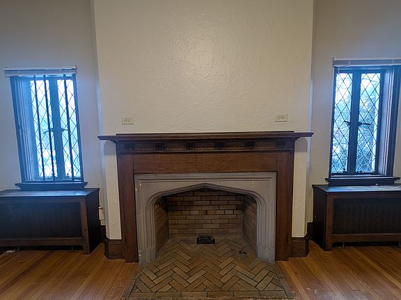 Original fireplace with detailed glass pantry style windows