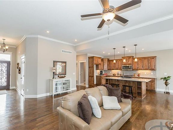 FRONT ENTRYWAY OPENS INTO THE GREAT ROOM, KITCHEN, DINING AREA. ALSO SEEN IN THIS PHOTO IS THE HALL INTO THE MUDROOM AREA (SEATING, LAUNDRY ROOM, AND PANTRY). (SIMULATED PHOTO)