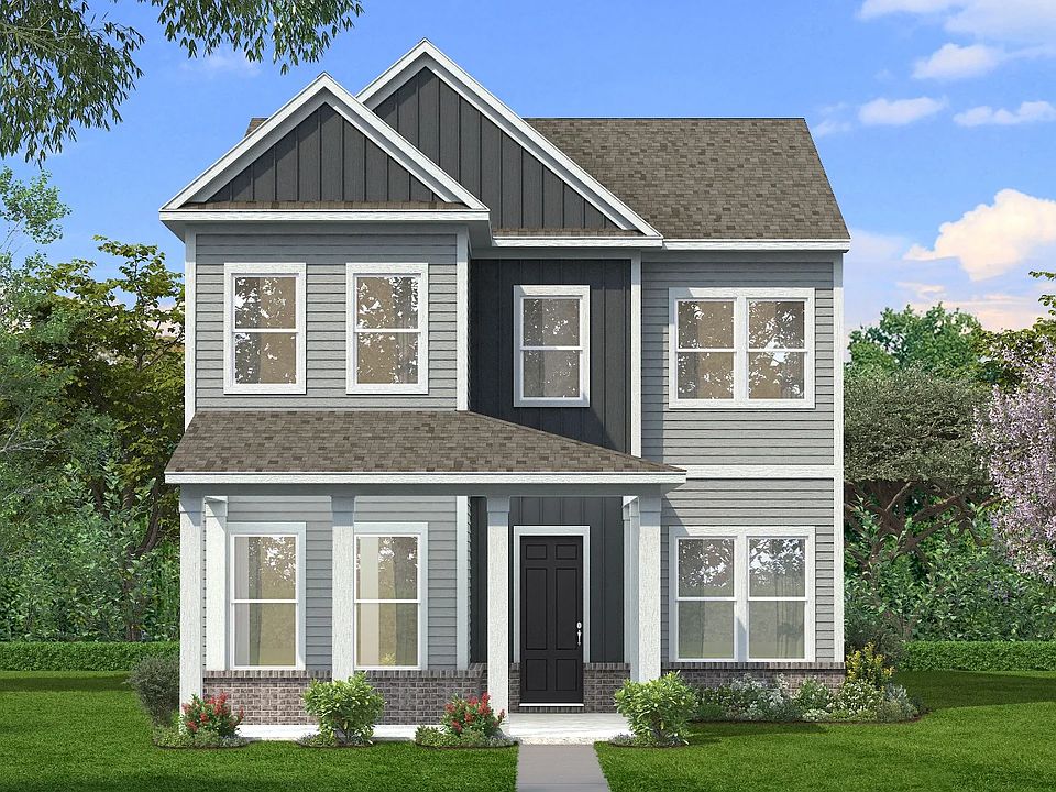 Exterior with two-tone Hardie siding with accents and covered front porch and brick water table