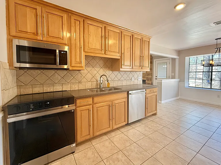 Kitchen with electric range, microwave, and diswasher