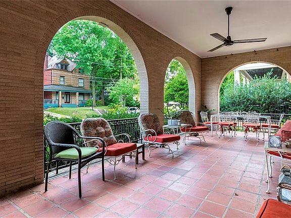 Wide Front Loggia Opens from French Doors in the Living Room to Extend Your Entertaining Space