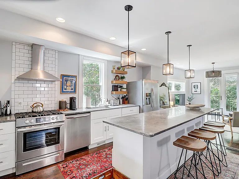 Chef's kitchen fully-equipped with dishes, utensils, microwave, and new appliances.