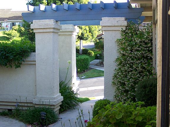 Beautiful arched entry in to your garden home on a greenbelt