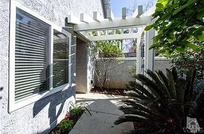 Inviting walkway up to front door with lush plants.