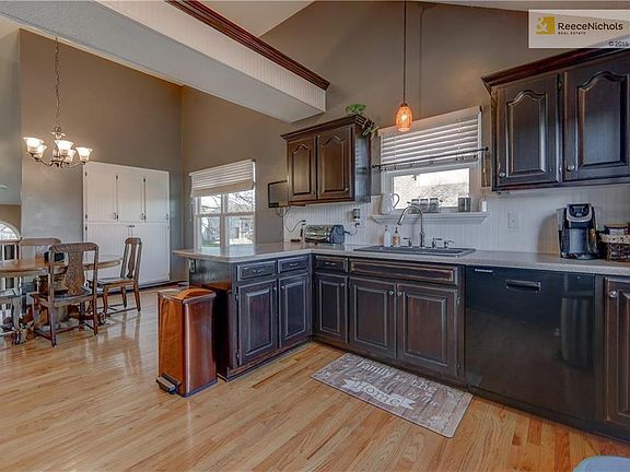 This bright and cheery kitchen has fresh paint, a built-in storage closet, hardwood flooring, vaulted ceiling and updated fixtures.