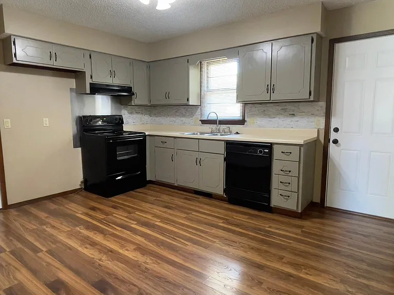 Kitchen with doors leading to Garage and Back Yard