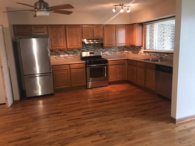 Kitchen with stainless steal appliances and tile backsplash