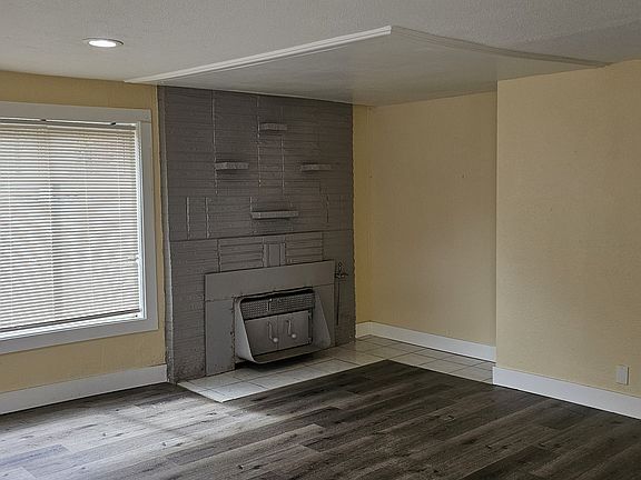 Cozy spacious living room with wood fire place as you enter the house.