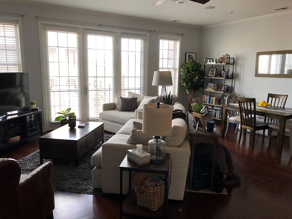 Living room, dining area in background