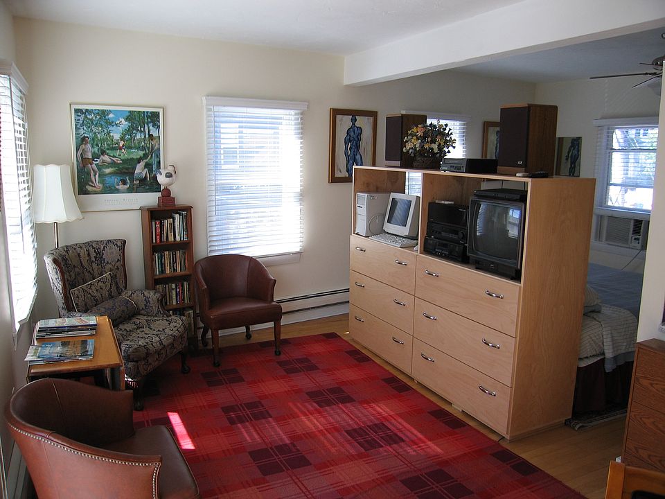 Sitting w/bed behind cabinet
