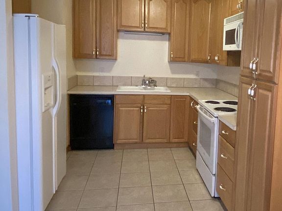 Kitchen with full size refrigerator, dishwasher, double sink, oven, and microwave. Lots of pantry space!