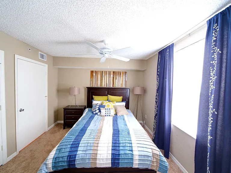 Bedroom with large window and ceiling fan at Gregory Cove in Jacksonville, FL