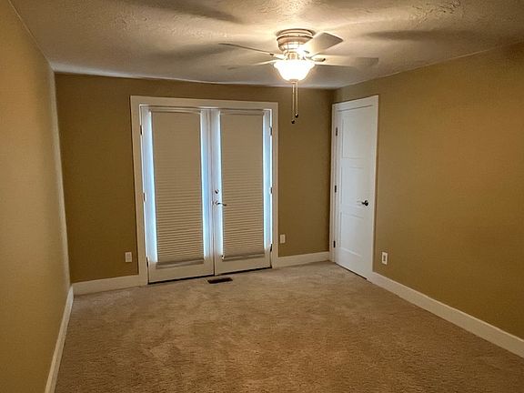 Bedroom and double doors out to patio