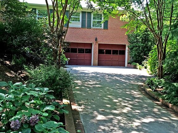 Brick Edged Concrete Driveway Leads To Garage