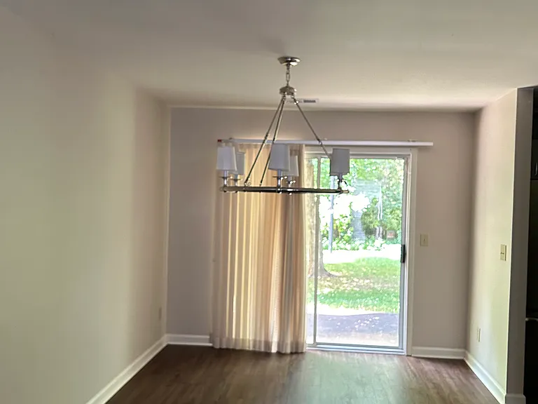 Dining Room with pic of New Chandelier and view of backyard