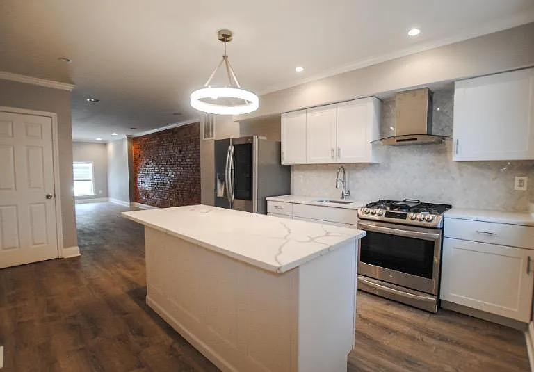 Walk in to an open first level; head to the back of the house to find the upgraded kitchen